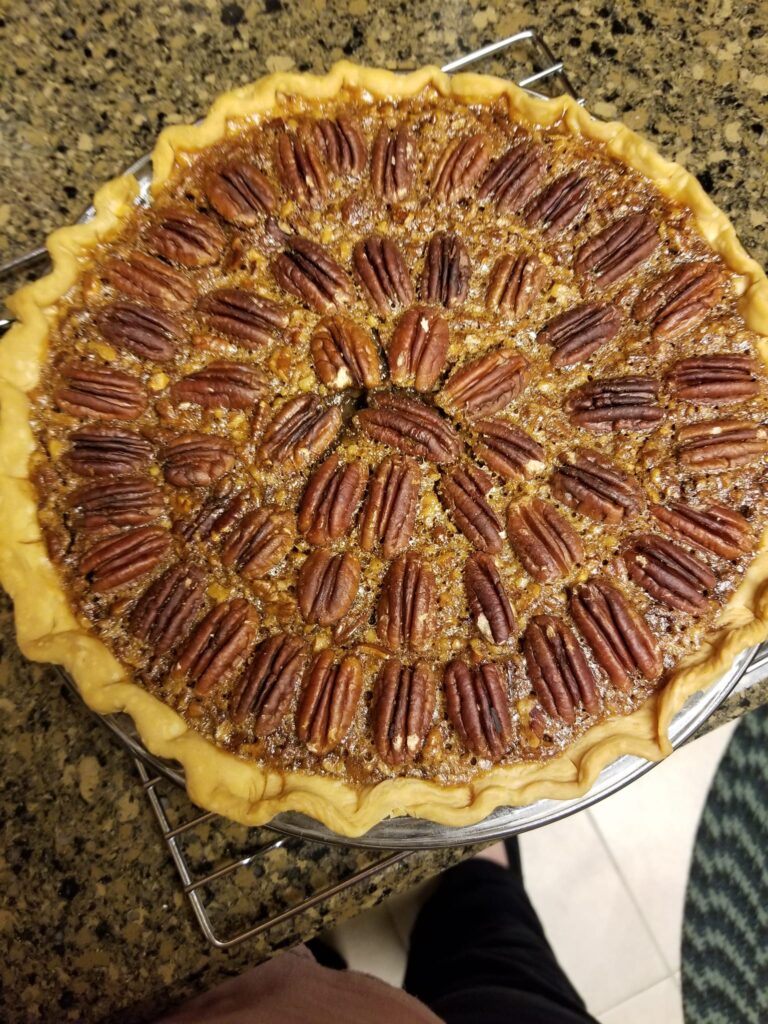 Pouring dark corn syrup into the Southern Pecan Pie filling bowl.