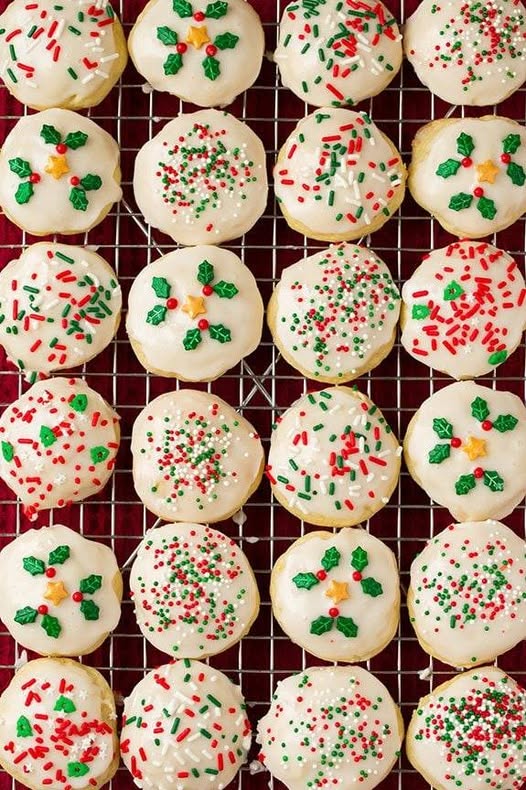 Drizzling lemon glaze over a fresh batch of Italian Ricotta Cookies