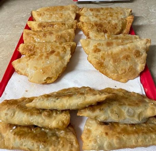 Golden brown Southern Fried Pies draining on a paper towel lined tray