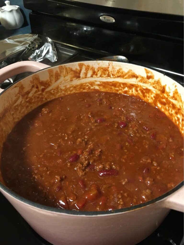 Close up of thick chili with kidney beans, diced tomatoes, and green chilies