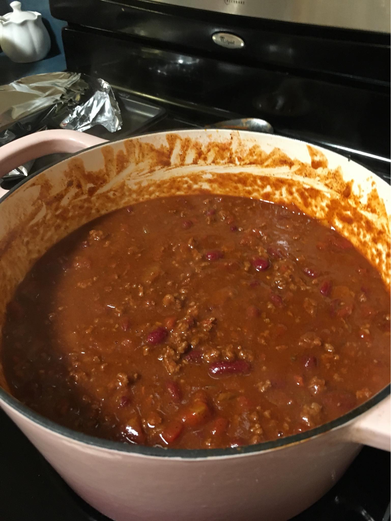 Close up of thick chili with kidney beans, diced tomatoes, and green chilies