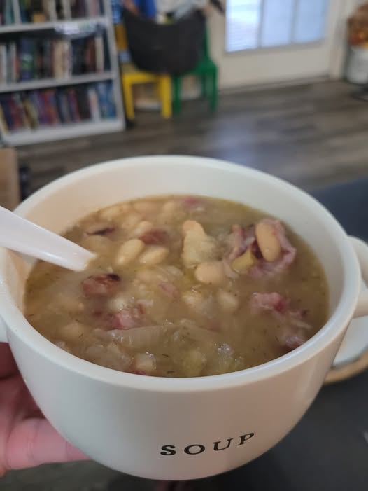 Instant Pot filled with creamy Northern Bean Soup and smoky ham hocks.